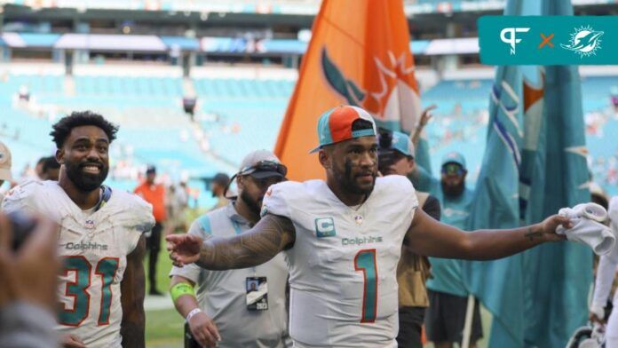 Miami Dolphins QB Tua Tagovailoa (1) and RB Raheem Mostert (31) react after a victory over the Carolina Panthers.