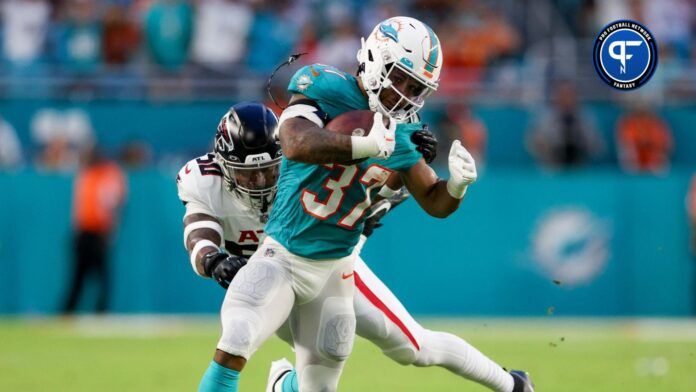 Myles Gaskin (37) breaks a tackle from Atlanta Falcons linebacker Tae Davis (50) in the second quarter at Hard Rock Stadium.