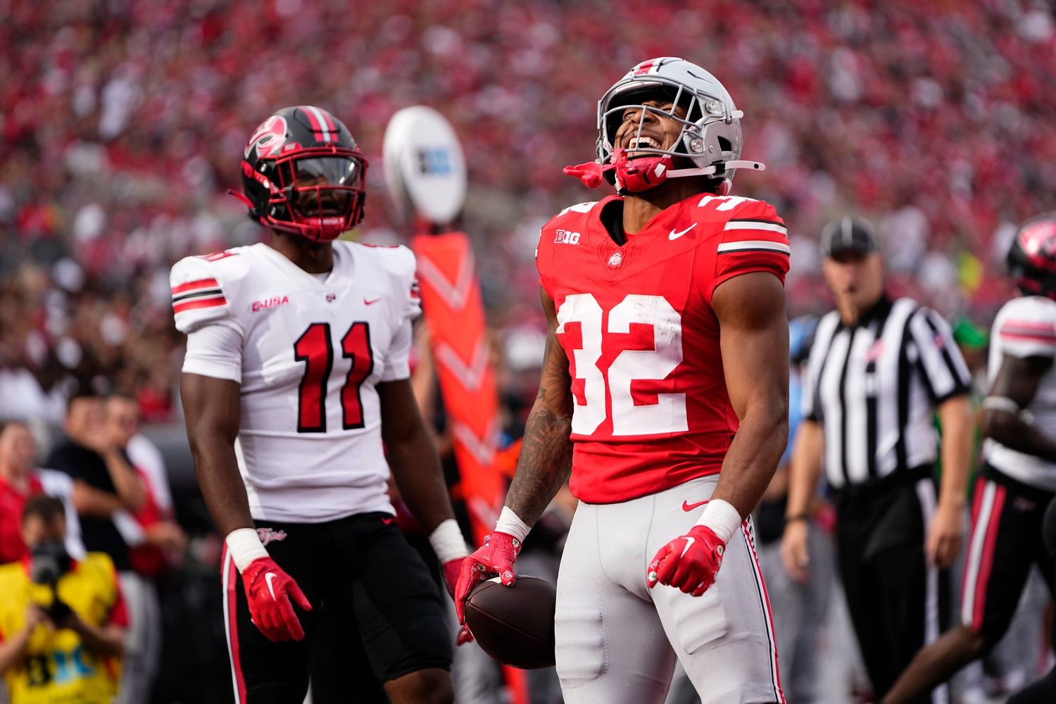 TreVeyon Henderson (32) celebrates a leap over a Western Kentucky Hilltoppers defensive back during the first half.