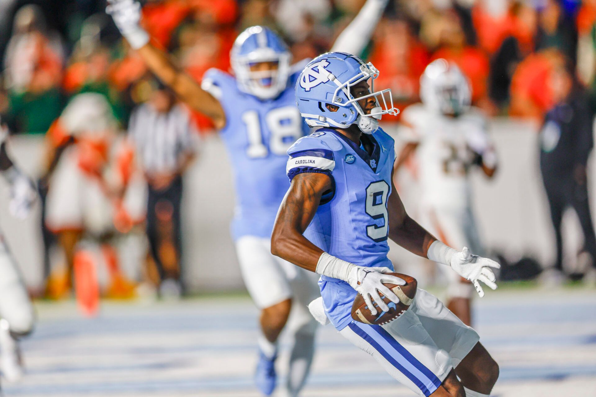 North Carolina Tar Heels wide receiver Devontez Walker (9) scores a touchdown against the Miami Hurricanes in the first half at Kenan Memorial Stadium.