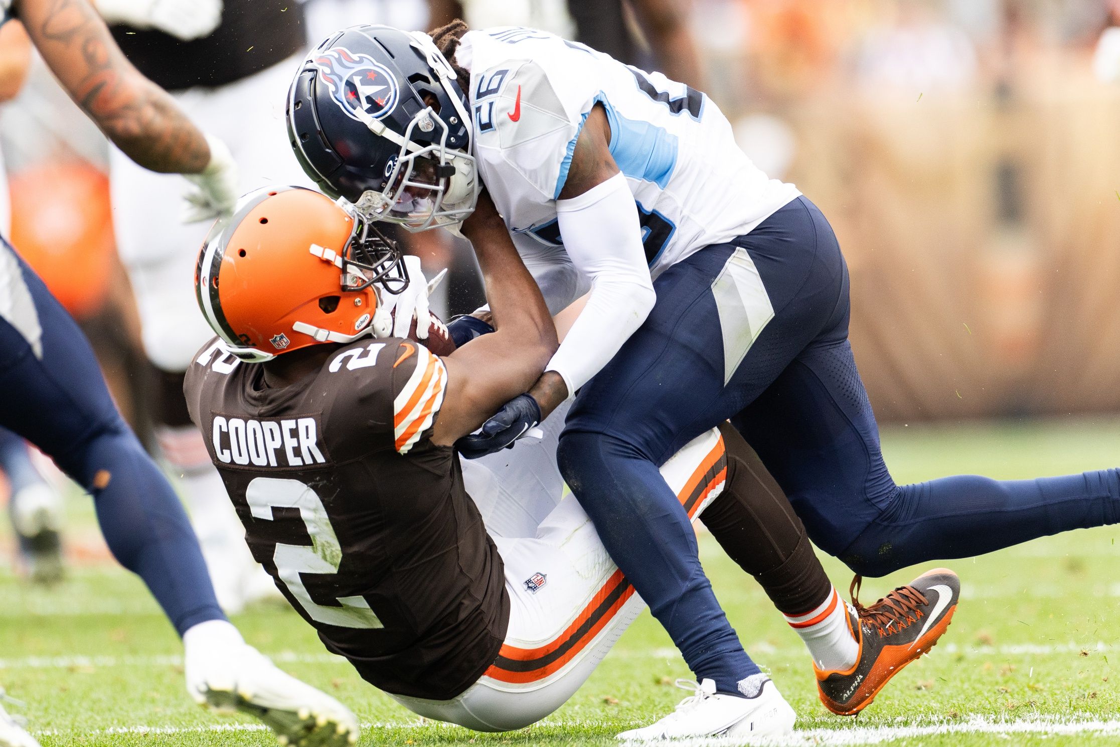 Kristian Fulton (26) tackles Cleveland Browns wide receiver Amari Cooper (2) during the third quarter at Cleveland Browns Stadium.