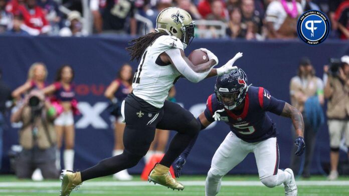 New Orleans Saints running back Alvin Kamara (41) runs with the ball as Houston Texans safety Jalen Pitre (5) defends during the first quarter at NRG Stadium.