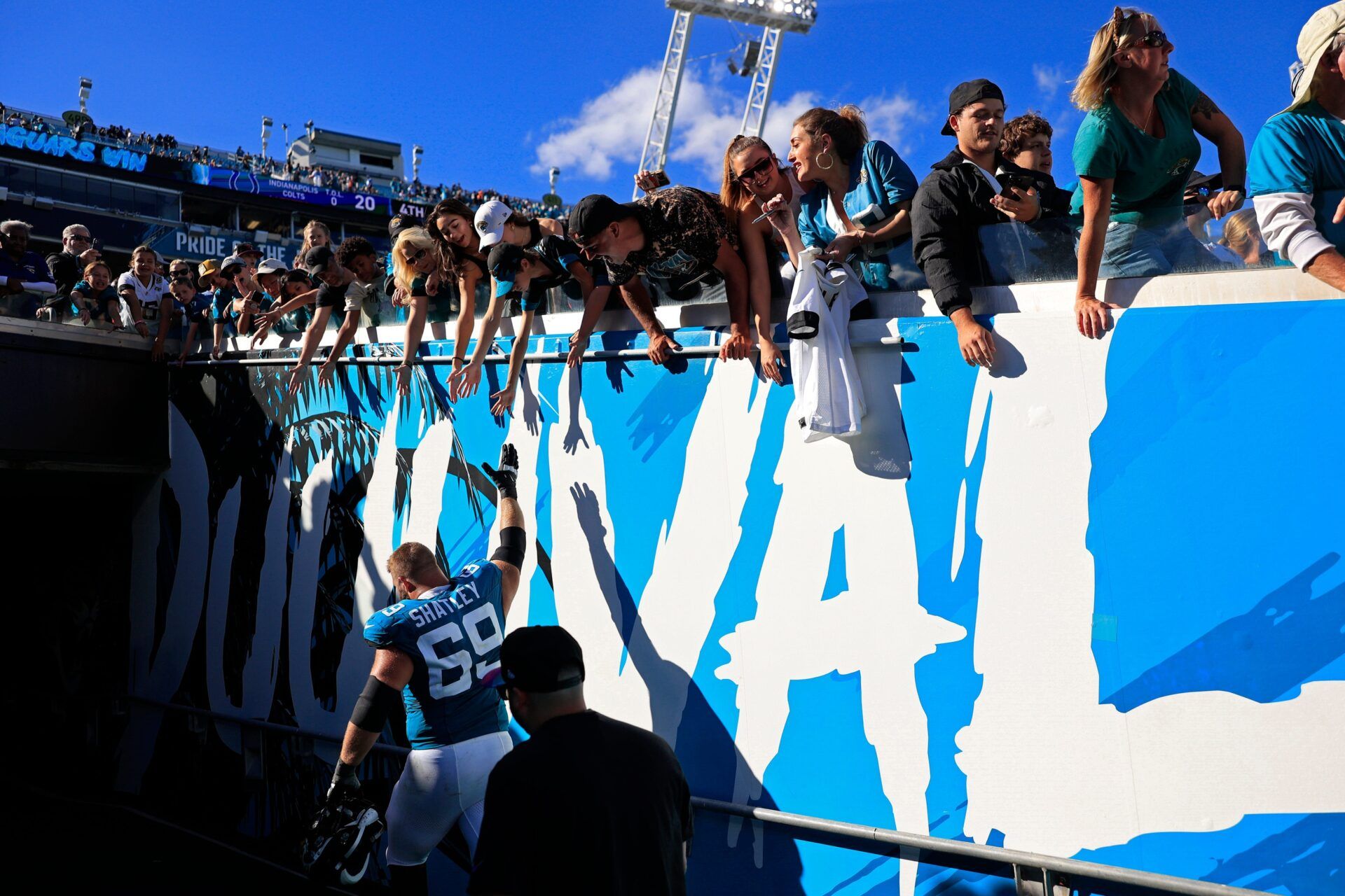 Jacksonville Jaguars center Tyler Shatley (69) high-fives fans after the game an NFL football matchup Sunday, Oct. 15, 2023 at EverBank Stadium in Jacksonville, Fla. The Jacksonville Jaguars defeated the Indianapolis Colts 37-20.