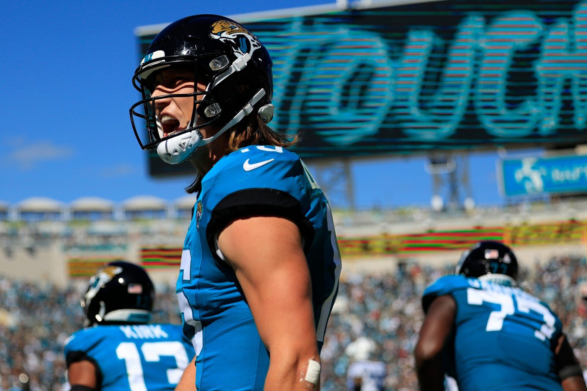 Jacksonville Jaguars QB Trevor Lawrence (16) screams in celebration after a touchdown pass.