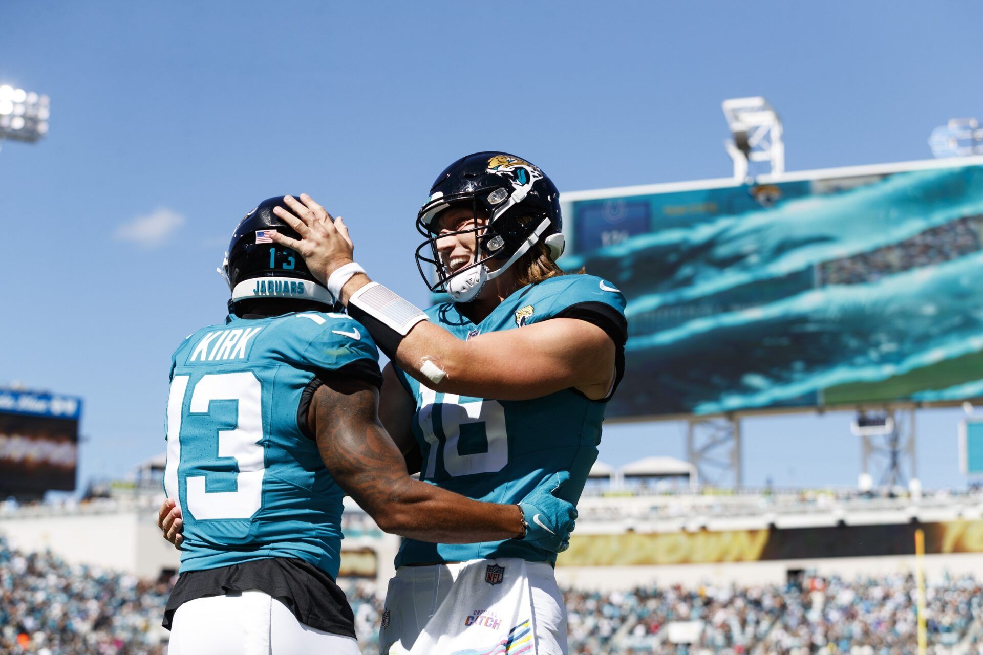 Jacksonville Jaguars quarterback Trevor Lawrence (16) and wide receiver Christian Kirk (13) celebrate a touchdown against the Indianapolis Colts.