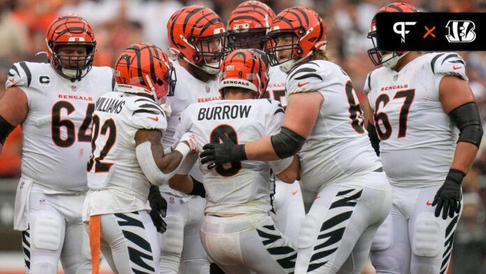 The Cincinnati Bengals offensive line helps QB Joe Burrow (9) to his feet.