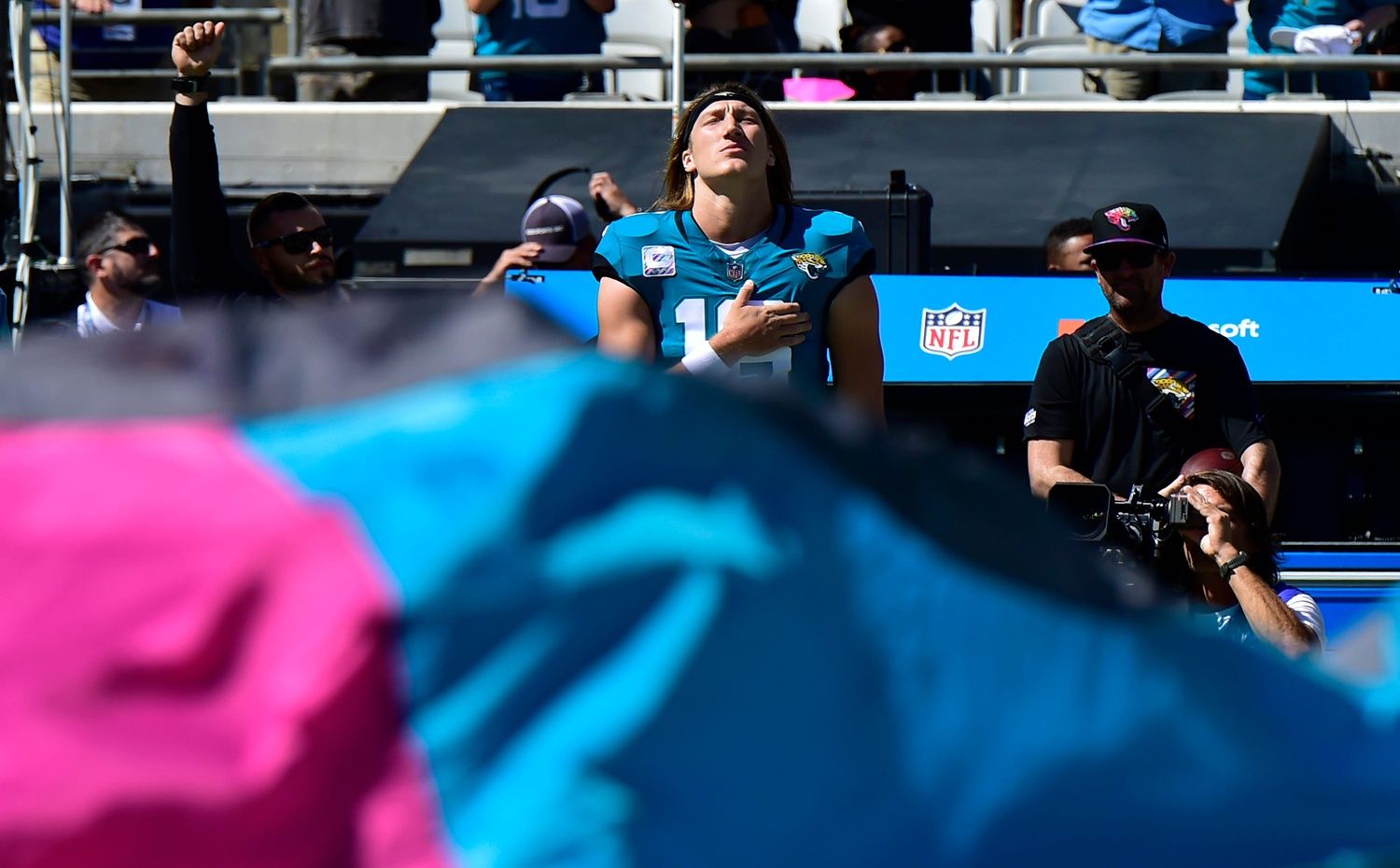 Jacksonville Jaguars QB Trevor Lawrence (16) holds his hand over his heart during the national anthem.