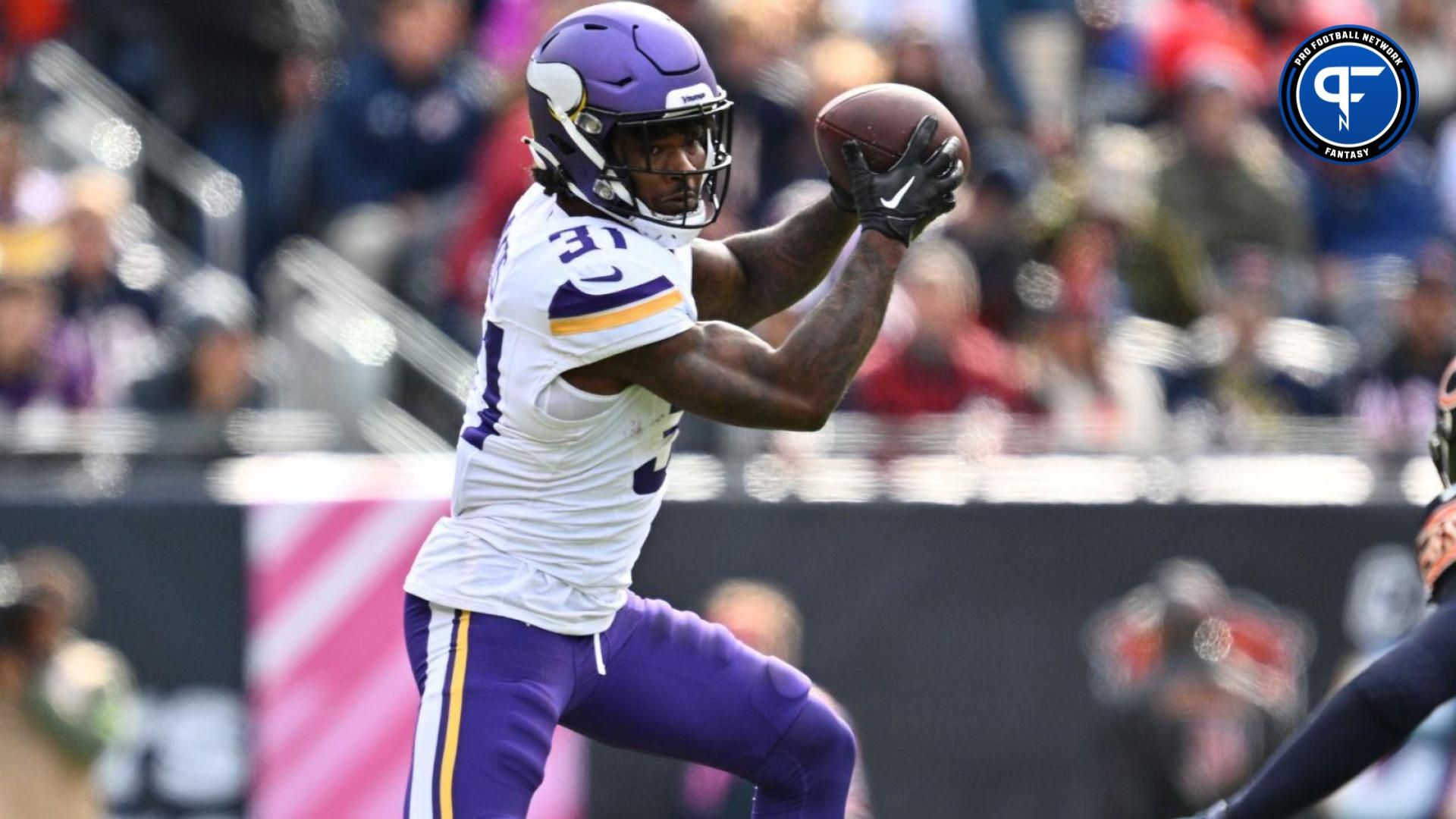 Cam Akers (31) catches a pass in the second half as Chicago Bears linebacker T.J. Edwards (53) closes in to defend at Soldier Field.
