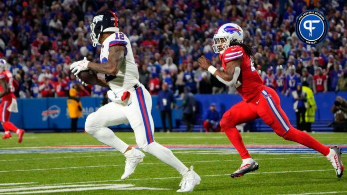 New York Giants tight end Darren Waller (12) runs with the ball after making a catch against Buffalo Bills linebacker Dorian Williams (42) during the second half at Highmark Stadium.