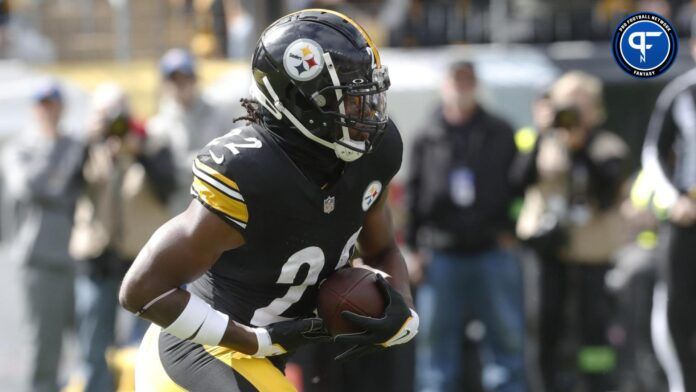 Najee Harris (22) runs the ball against the Baltimore Ravens during the first quarter at Acrisure Stadium.