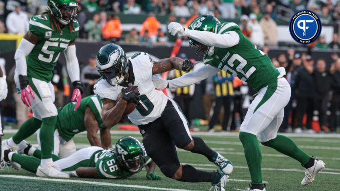 Philadelphia Eagles running back D'Andre Swift (0) scores a touchdown while being hit by New York Jets safety Tony Adams (22) during the first half at MetLife Stadium.