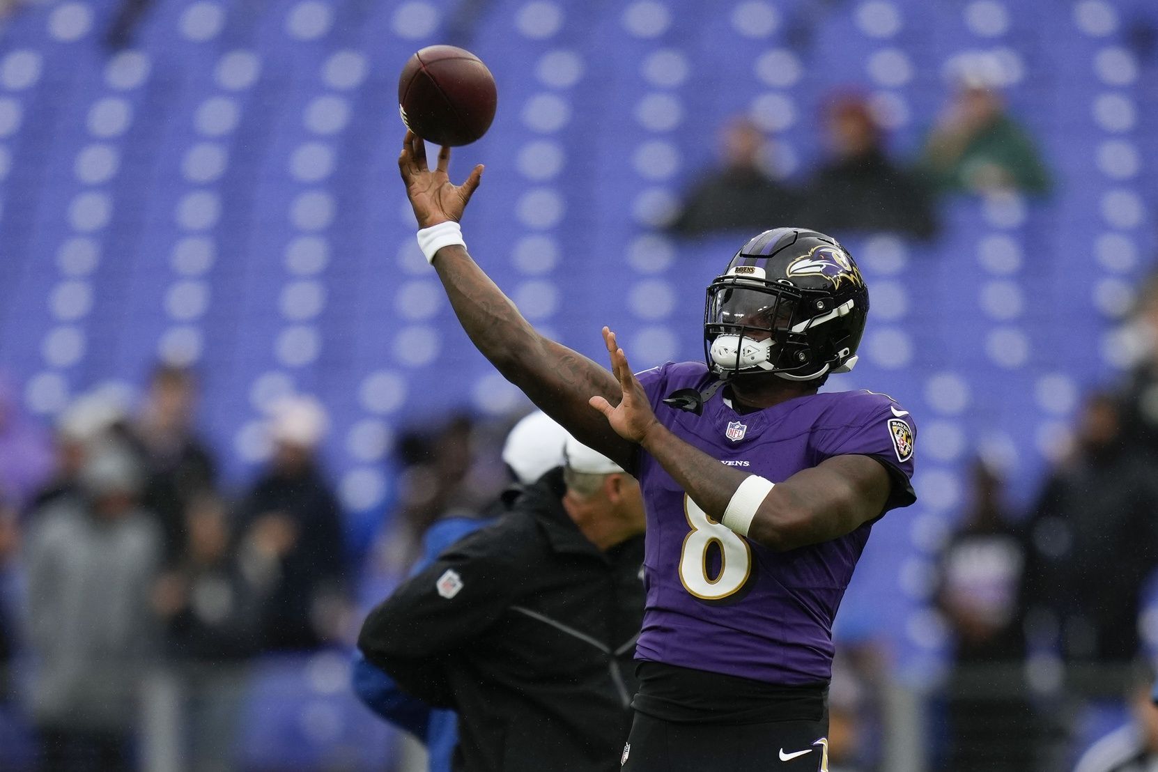 Lamar Jackson (8) throws a pass during pregame warm ups before a game against the Indianapolis Colts at M&T Bank Stadium.