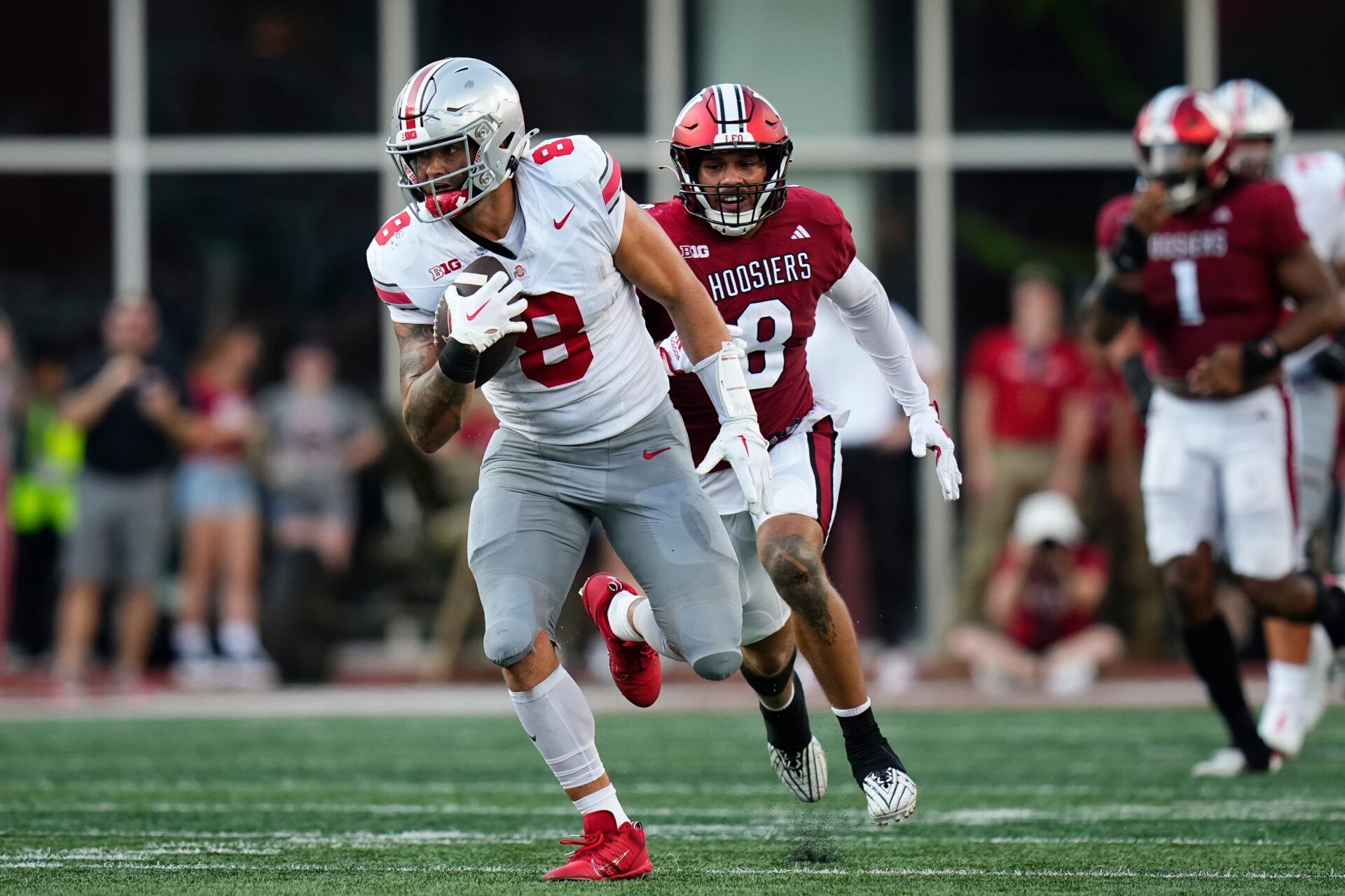 Ohio State Buckeyes tight end Cade Stover (8) runs upfield past Indiana Hoosiers linebacker Jared Casey (8) during the NCAA football game at Indiana University Memorial Stadium.