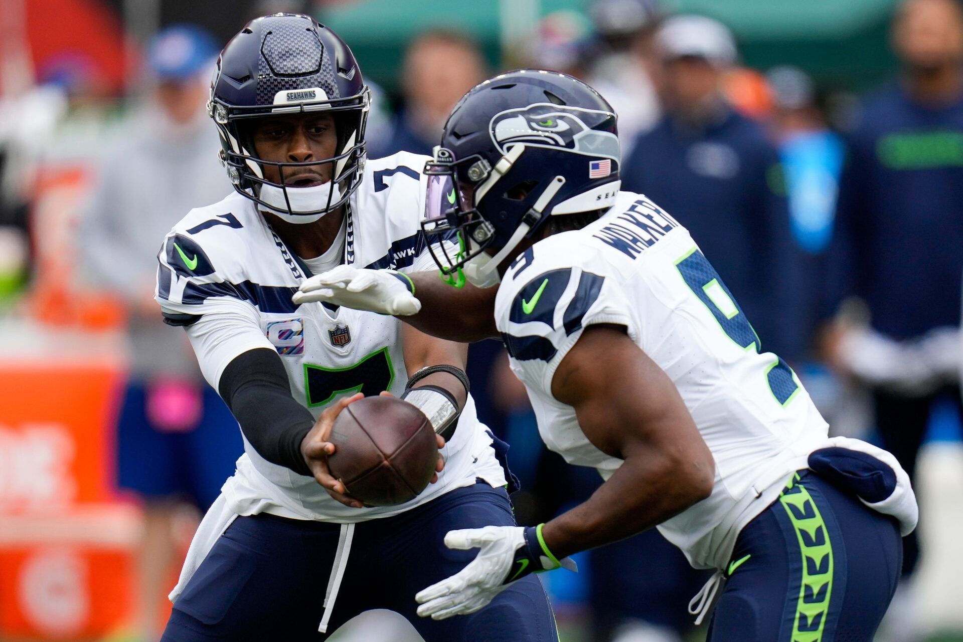 Geno Smith (7) hands off to Seattle Seahawks running back Kenneth Walker III (9) in the first quarter of the NFL Week 6 game between the Cincinnati Bengals and the Seattle Seahawks at Paycor Stadium.