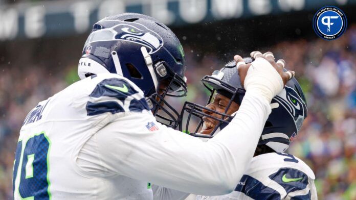 Seattle Seahawks running back Kenneth Walker III (9) celebrates with offensive tackle Raiqwon O'Neal (79) after rushing for a touchdown against the Carolina Panthers during the fourth quarter at Lumen Field.