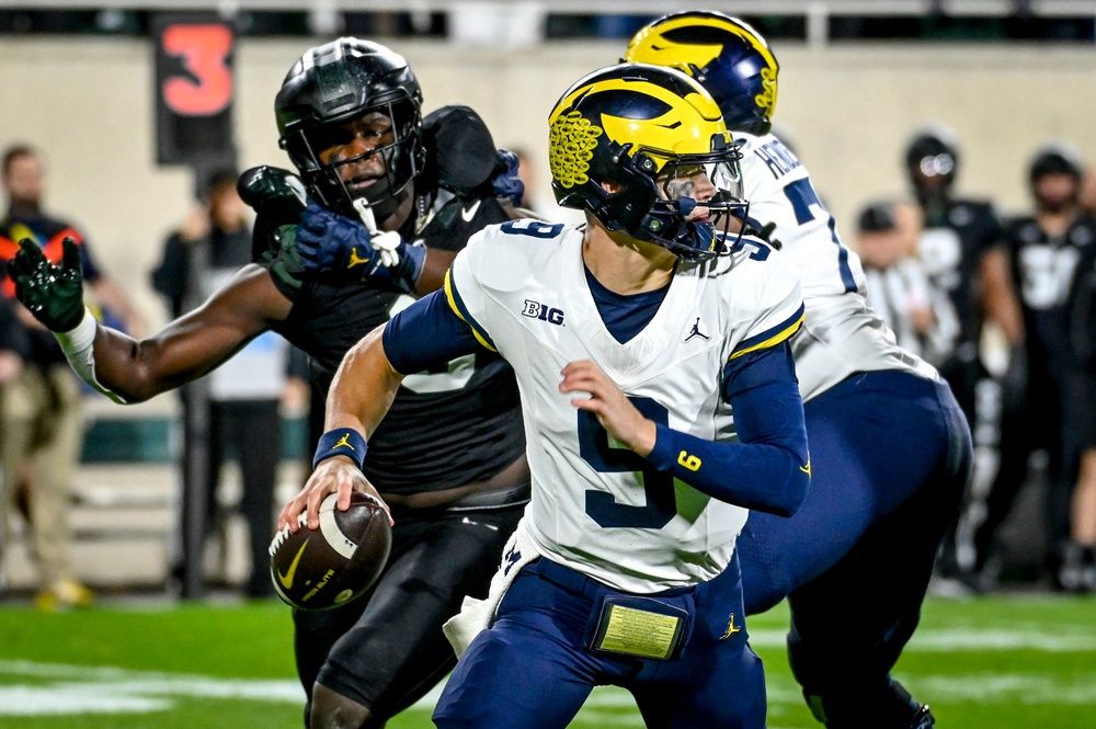 Michigan QB J.J. McCarthy (9) looks to throw against Michigan State.