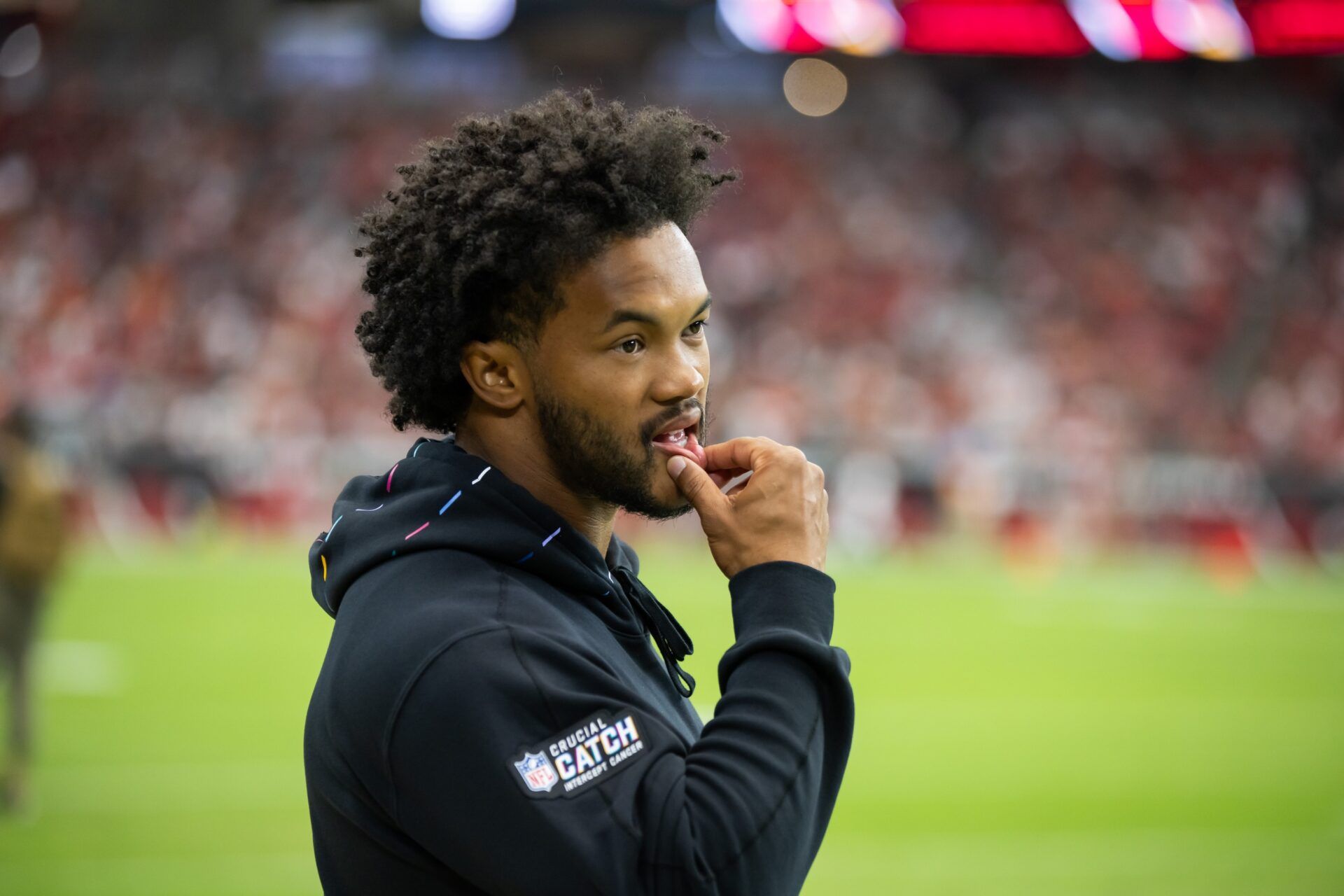 Arizona Cardinals QB Kyler Murray watching on the sidelines during the team's game against the Cincinnati Bengals.