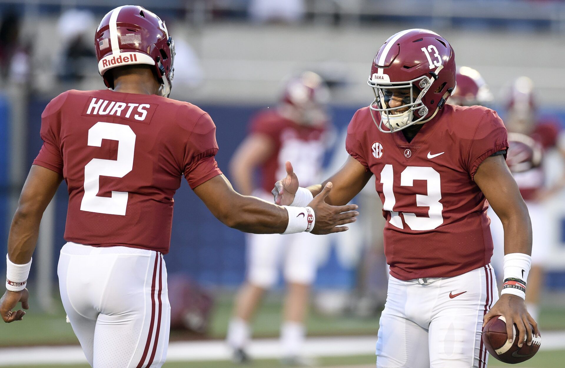 Alabama Crimson Tide quarterback Jalen Hurts (2) and quarterback Tua Tagovailoa (13) interact before the start of their game against the Louisville Cardinals at Camping World Stadium.