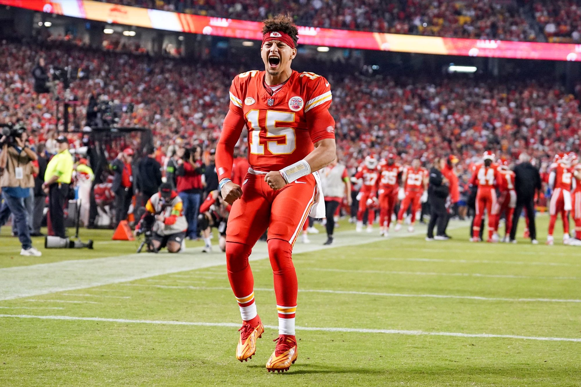 Kansas City Chiefs quarterback Patrick Mahomes (15) celebrates toward fans against the Denver Broncos prior to a game at GEHA Field at Arrowhead Stadium.