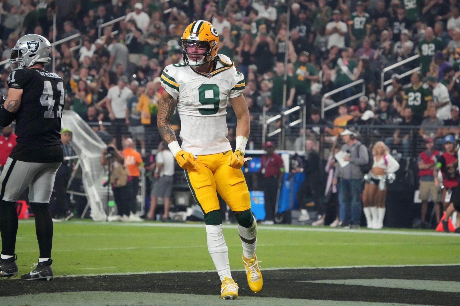 Christian Watson (9) reacts after a 77-yard reception in the second half against the Las Vegas Raiders at Allegiant Stadium.