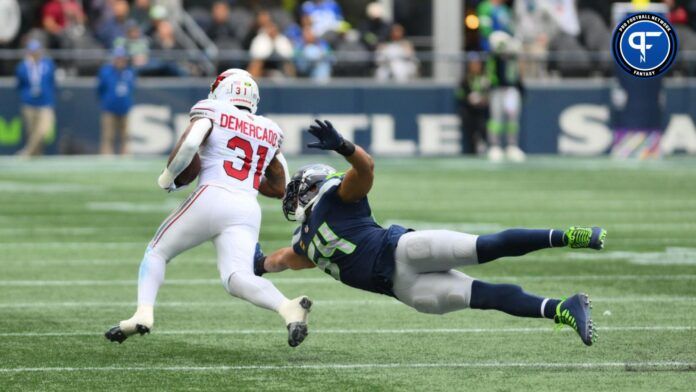 Seattle Seahawks linebacker Bobby Wagner (54) dives for Arizona Cardinals running back Emari Demercado (31) during the first half at Lumen Field.