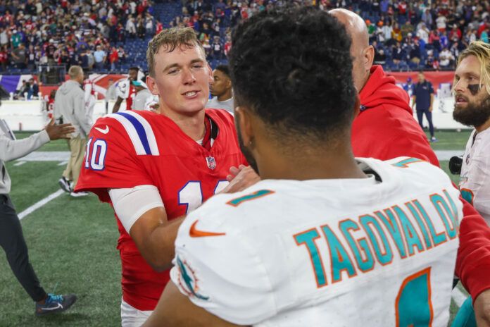 New England Patriots quarterback Mac Jones (10) talks to Miami Dolphins quarterback Tua Tagovailoa (1) after a game at Gillette Stadium.