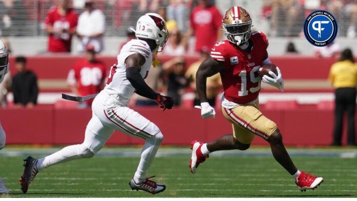 San Francisco 49ers wide receiver Deebo Samuel (19) runs with the ball after making a catch next to Arizona Cardinals cornerback Kei'Trel Clark (13).