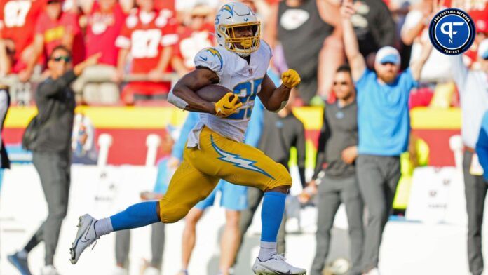 Joshua Kelley (25) runs for a touchdown during the second half against the Kansas City Chiefs at GEHA Field at Arrowhead Stadium.