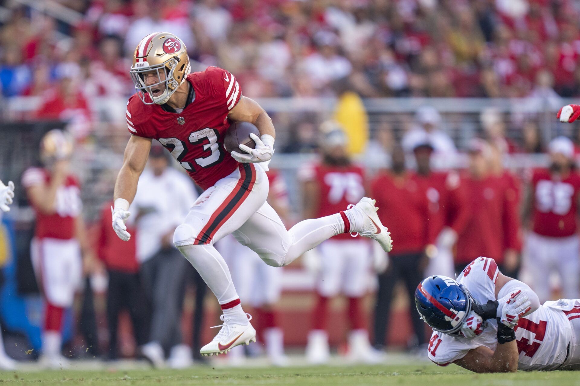 San Francisco 49ers RB Christian McCaffrey (23) breaks a tackle against the New York Giants.