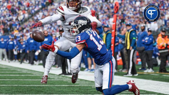 Washington Commanders cornerback Benjamin St-Juste (25) breaks up a pass intended for New York Giants wide receiver Jalin Hyatt (13) during the first half at MetLife Stadium.