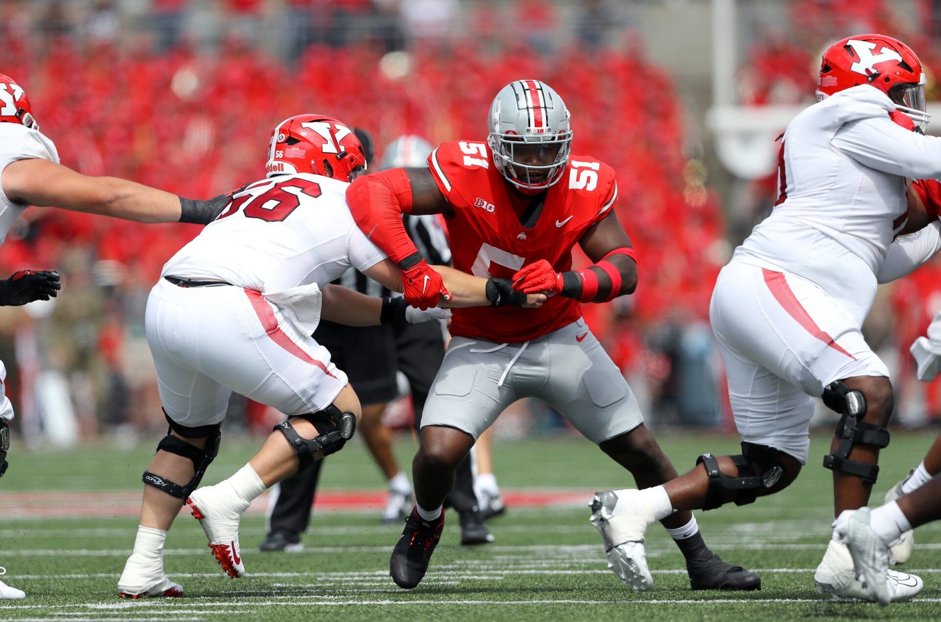 Ohio State Buckeyes defensive tackle Michael Hall Jr. (51) gets past the block of Youngstown State Penguins offensive lineman Aidan Parker (56) during the first half at Ohio Stadium.