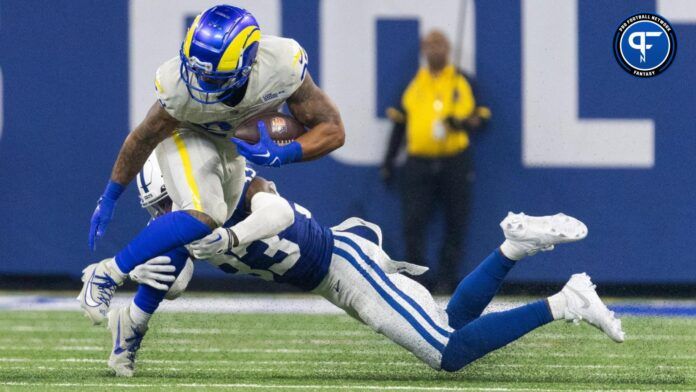 Los Angeles Rams running back Kyren Williams (23) runs the ball while Indianapolis Colts cornerback Dallis Flowers (33) defends.