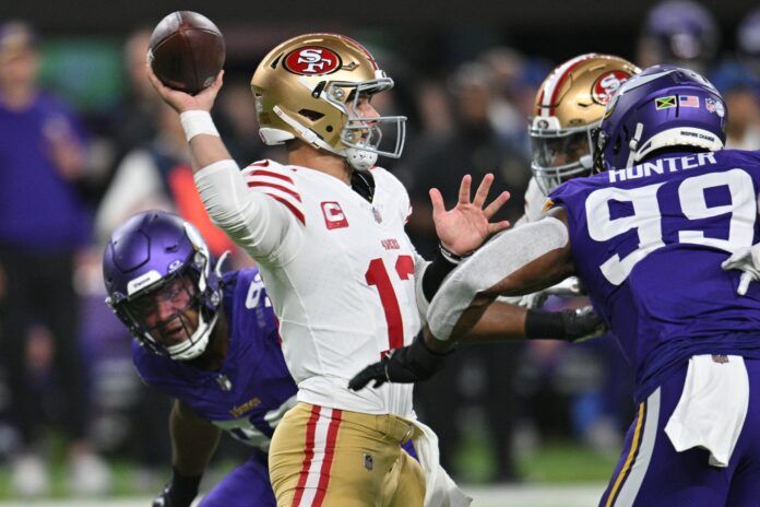 Brock Purdy (13) throws a pass as Minnesota Vikings linebacker Danielle Hunter (99) and linebacker D.J. Wonnum (left) rush in during the first quarter at U.S. Bank Stadium.