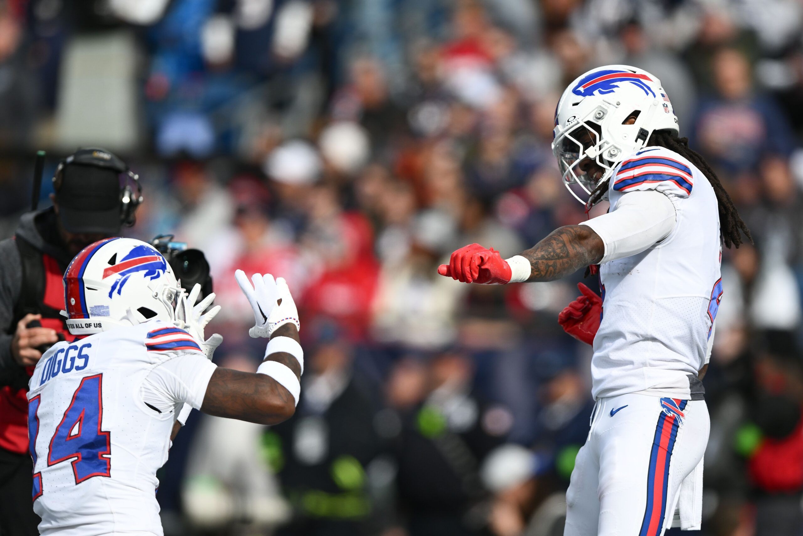 James Cook (4) celebrates with wide receiver Stefon Diggs (14) after scoring a touchdown against the New England Patriots during the second half at Gillette Stadium.