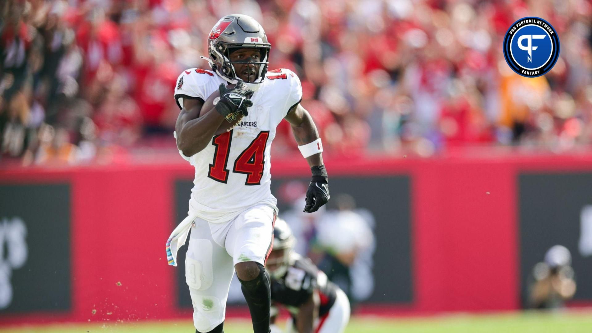 Tampa Bay Buccaneers wide receiver Chris Godwin (14) runs with the ball against the Atlanta Falcon in the fourth quarter at Raymond James Stadium.