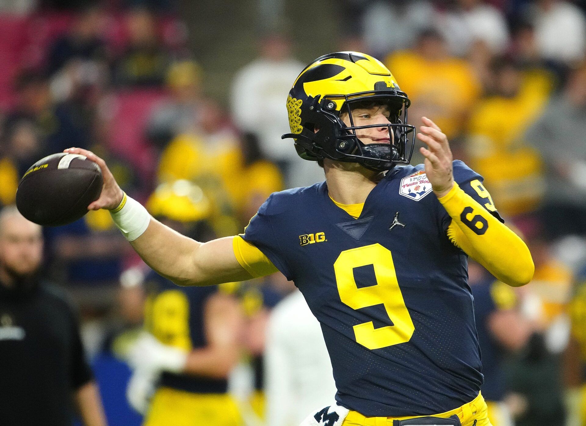 Michigan quarterback JJ McCarthy (9) throws a pass during the pregame before the Fiesta Bowl at State Farm Stadium.