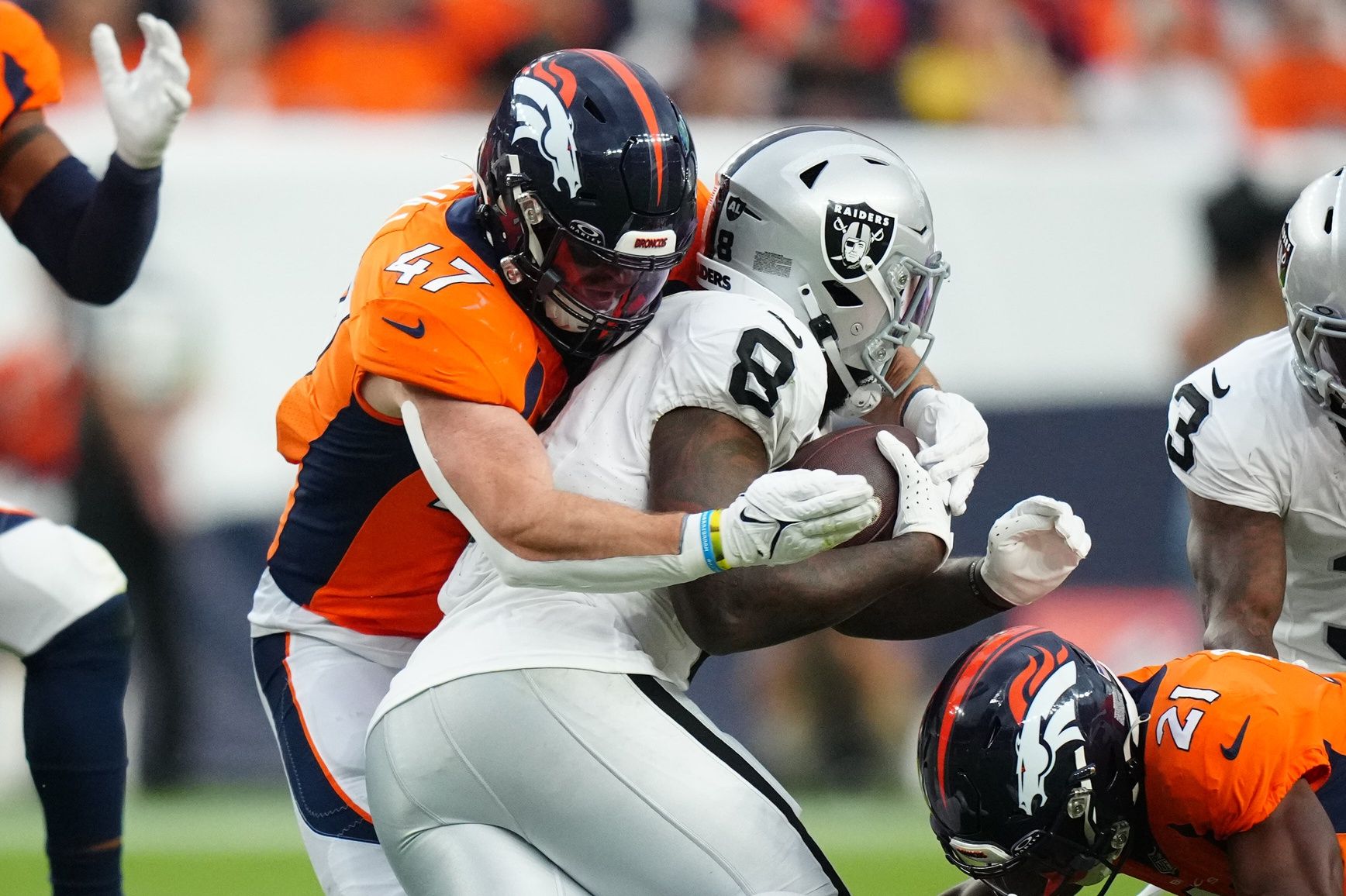 Denver Broncos LB Josey Jewell (47) tackles Las Vegas Raiders RB Josh Jacobs (8).