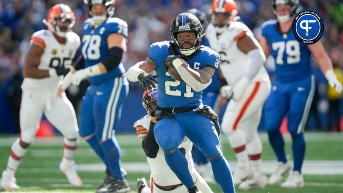 Indianapolis Colts RB Zack Moss (21) tries to break a tackle against the Cleveland Browns.