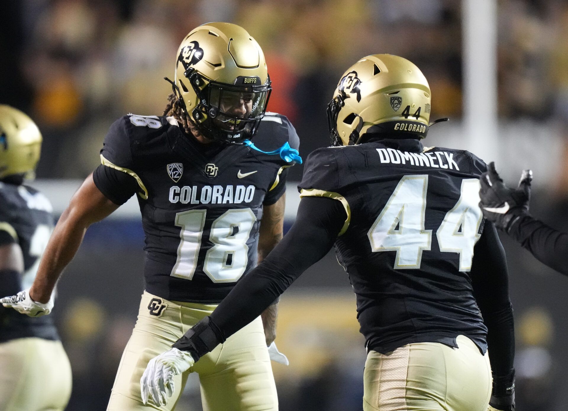 Colorado Buffaloes wide receiver Adam Hopkins (18) and (44) and linebacker Jordan Domineck (44) celebrate a special teams play in the first half against the Stanford Cardinal at Folsom Field.