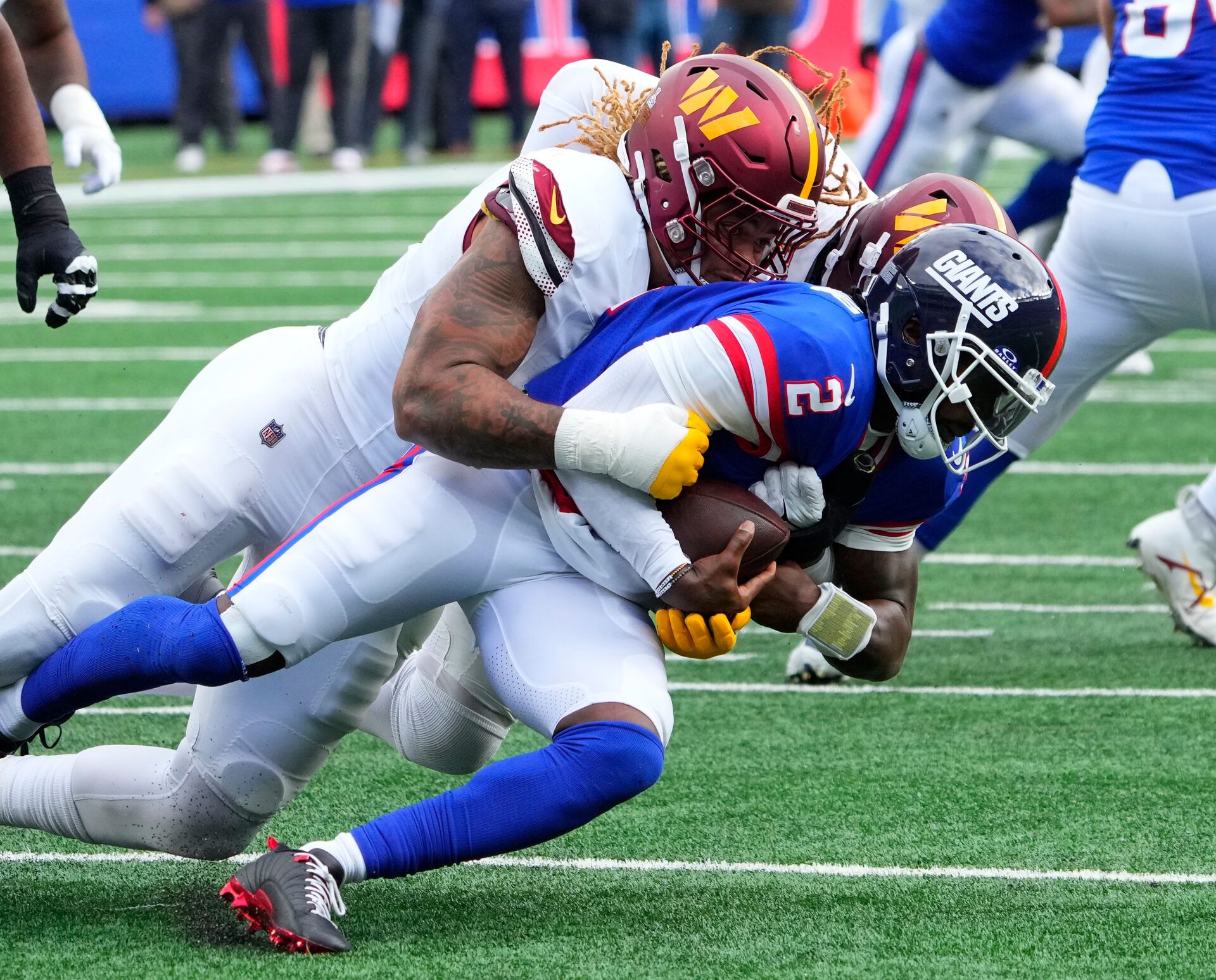 Washington Commanders defensive end Chase Young (99) sacks New York Giants quarterback Tyrod Taylor (2) in the second half at MetLife Stadium.