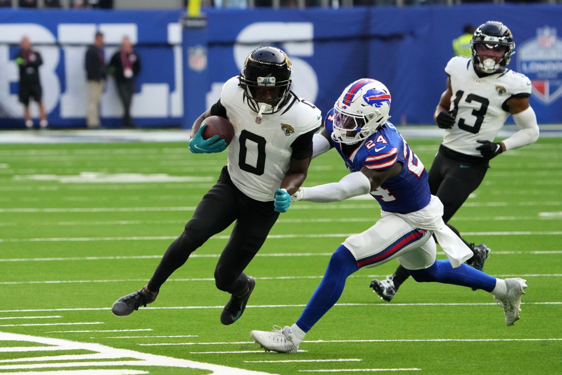 Jacksonville Jaguars wide receiver Calvin Ridley (0) carries the ball against Buffalo Bills cornerback Kaiir Elam (24) during the second half of an NFL International Series game at Tottenham Hotspur Stadium.