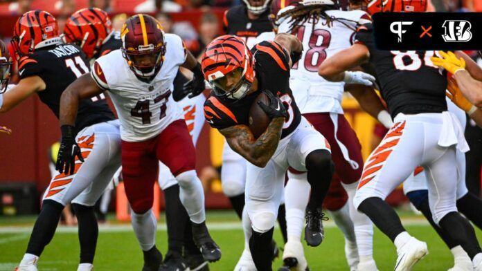 Cincinnati Bengals running back Chase Brown (30) carries the ball as Washington Commanders linebacker Khaleke Hudson (47) looks on during the first half at FedExField.