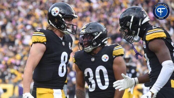 Pittsburgh Steelers quarterback Kenny Pickett (8) celebrates a game-winning touchdown with wide receiver George Pickens (14) and running back Jaylen Warren (30) during the fourth quarter against the Baltimore Ravens at Acrisure Stadium.