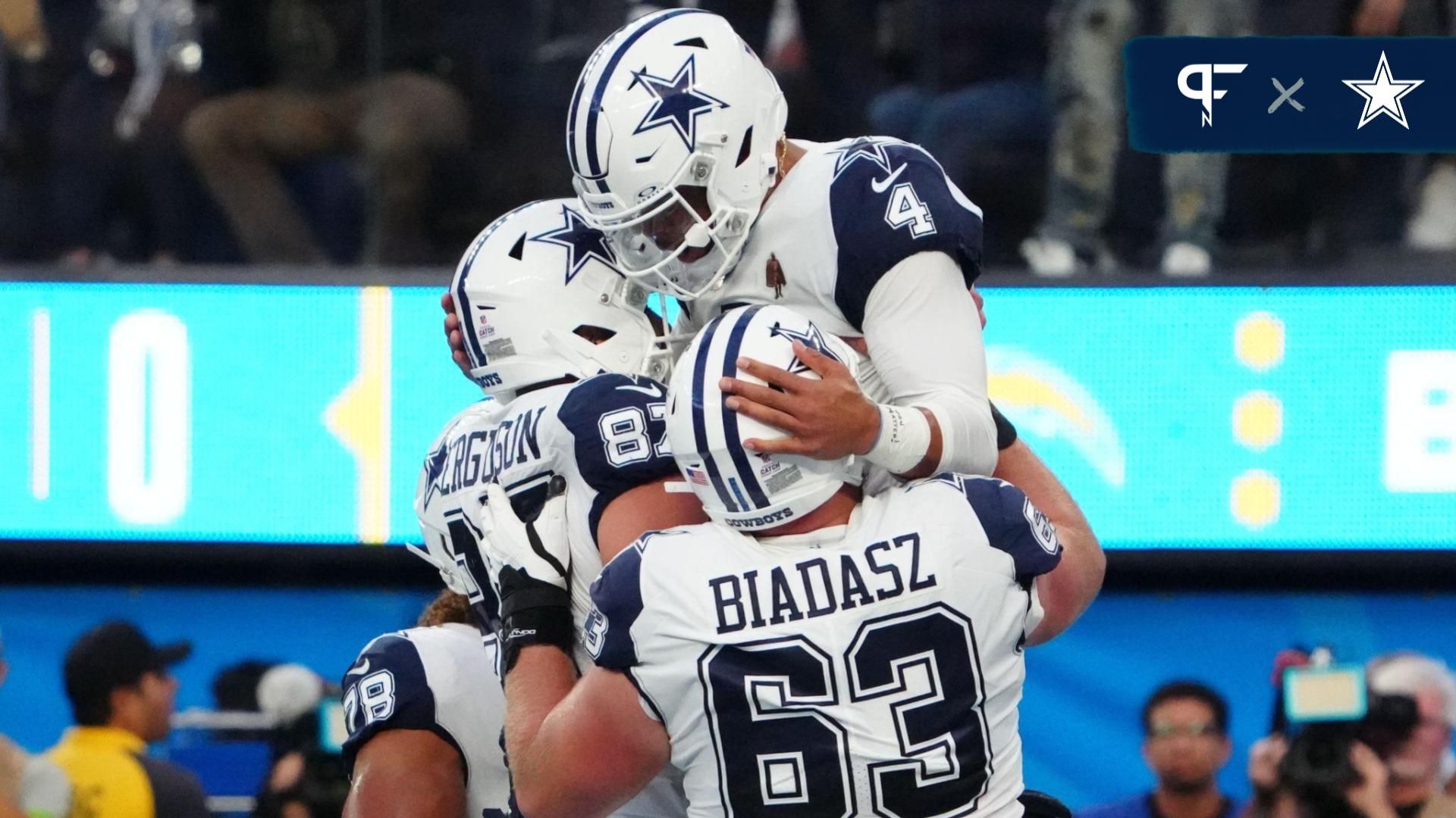 Dak Prescott (4) celebrates with tight end Jake Ferguson (87) and center Tyler Biadasz (63) after scoring on an 18-yard touchdown run against the Los Angeles Chargers in the first half at SoFi Stadium.