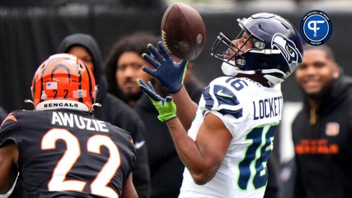 Tyler Lockett (16) catches a pass along the sideline as Cincinnati Bengals cornerback Chidobe Awuzie (22) defends in the second quarter.