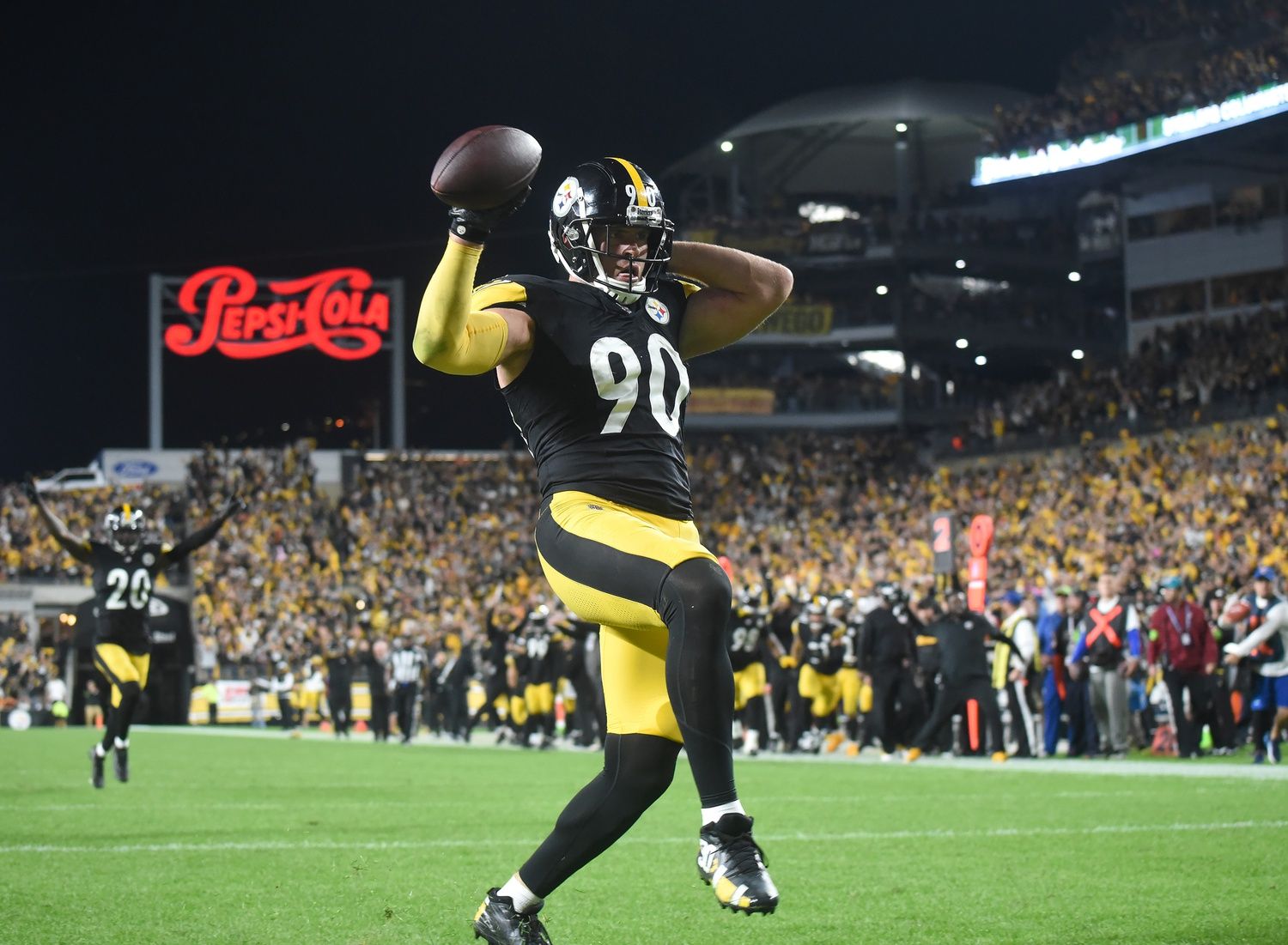 T.J. Watt (90) heads into the endzone for a touchdown after recovering a fumble in the fourth quarter against the Cleveland Browns at Acrisure Stadium.