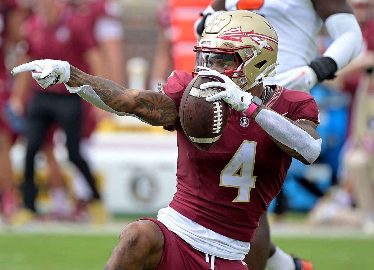 Keon Coleman (4) celebrates after catching a pass over Syracuse Orange defensive back Jason Simmons Jr. (6) (not pictured) during the first quarter at Doak S. Campbell Stadium.