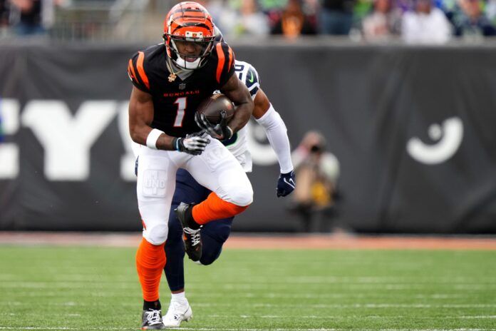 Cincinnati Bengals wide receiver Ja'Marr Chase (1) catches a pass as Seattle Seahawks cornerback Riq Woolen (27) defends in the second quarter during an NFL football game between the Seattle Seahawks and the Cincinnati Bengals Sunday, Oct. 15, 2023, at Paycor Stadium in Cincinnati.