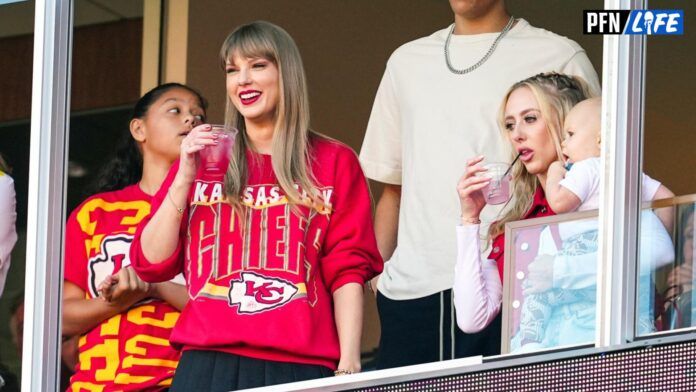 Taylor Swift watches the action with Jackson Mahomes and Brittany Mahomes during the first half at GEHA Field at Arrowhead Stadium.