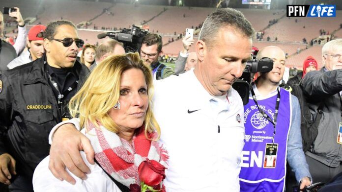 Urban Meyer and wife Shelley Meyer walk off the field after the 2019 Rose Bowl against the Washington Huskies at the Rose Bowl.